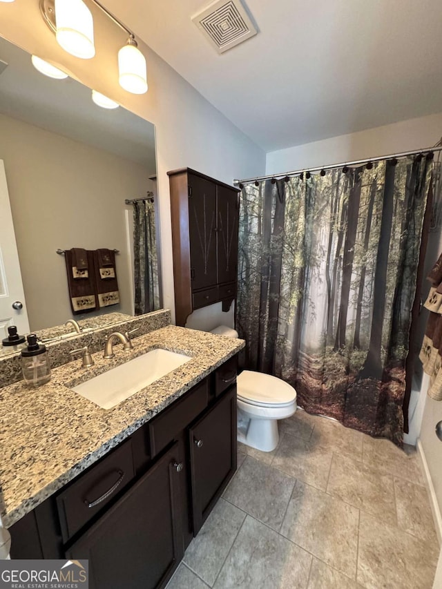 bathroom with toilet and vanity