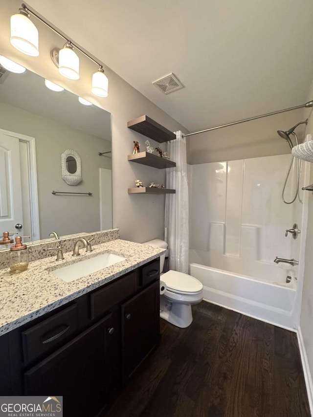 full bathroom with toilet, wood-type flooring, vanity, and shower / bath combo with shower curtain