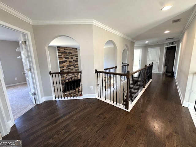 hall featuring dark hardwood / wood-style floors and crown molding