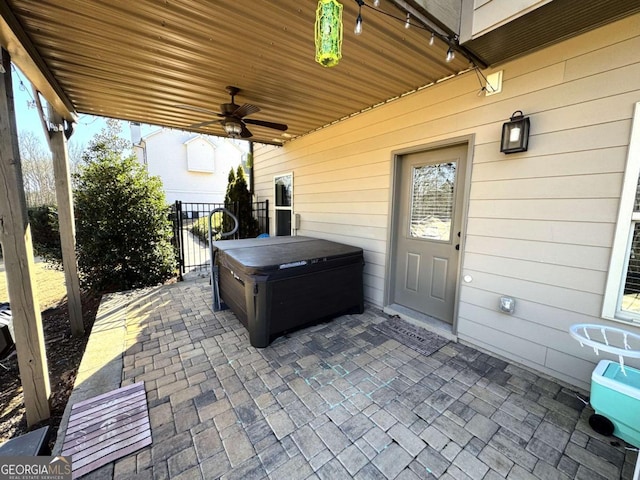 view of patio / terrace featuring ceiling fan and a hot tub