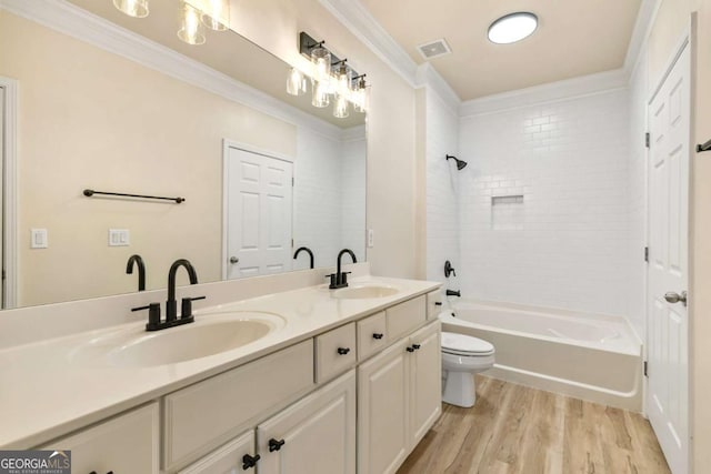 full bathroom with toilet, vanity, shower / washtub combination, hardwood / wood-style flooring, and ornamental molding