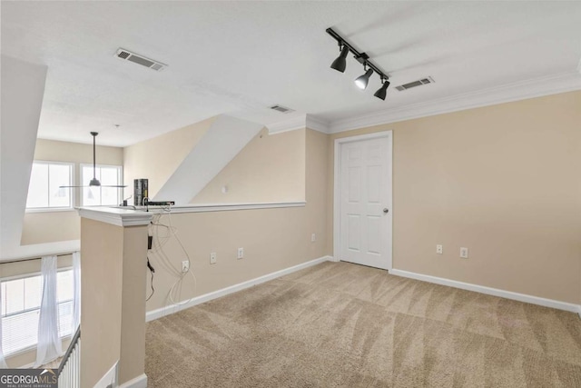 interior space with ornamental molding and rail lighting