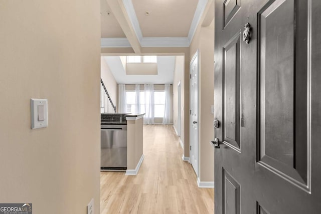 corridor with light wood-type flooring and crown molding