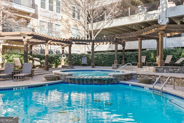 view of pool featuring a pergola, pool water feature, a hot tub, and a patio