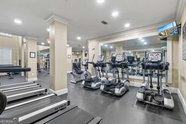 exercise room with crown molding and decorative columns