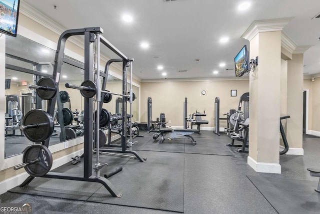 exercise room featuring ornate columns and crown molding