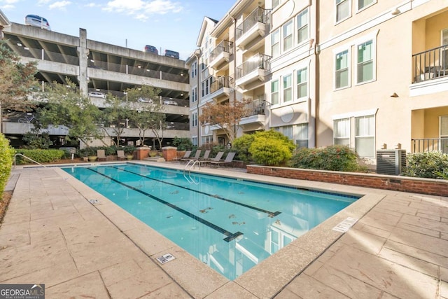 view of pool featuring cooling unit