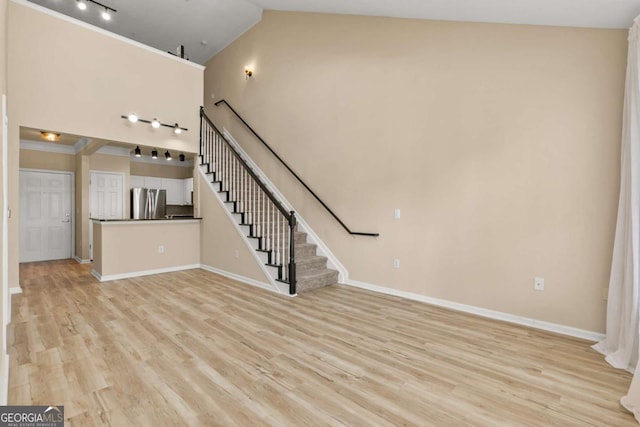 unfurnished living room with lofted ceiling and light hardwood / wood-style floors