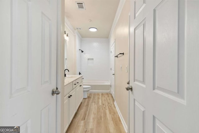 hall featuring light hardwood / wood-style floors, sink, and ornamental molding