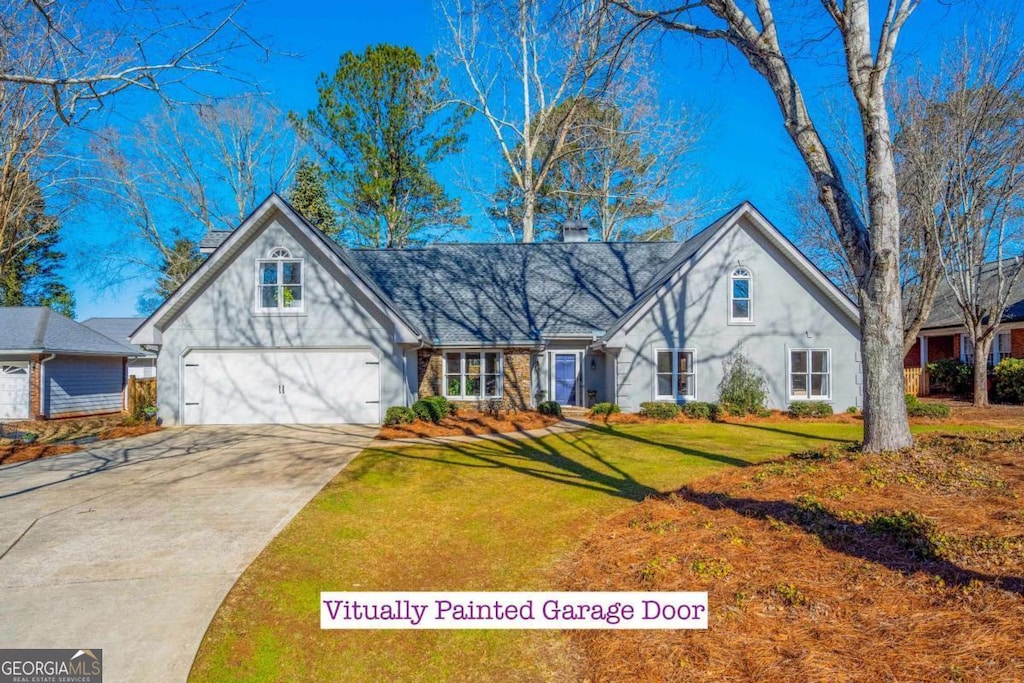 view of front facade with a garage and a front yard