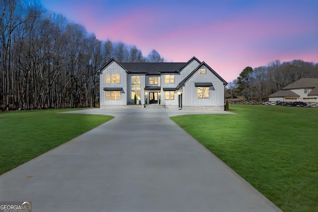 modern farmhouse style home with a yard