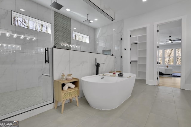 bathroom featuring ceiling fan, tile patterned flooring, and plus walk in shower