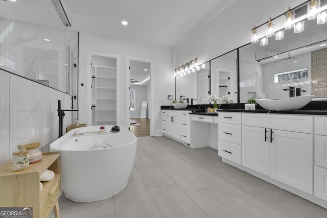 bathroom with vanity, tile patterned floors, and plus walk in shower