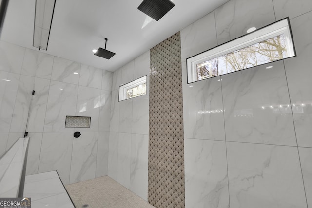 bathroom with a wealth of natural light and tiled shower