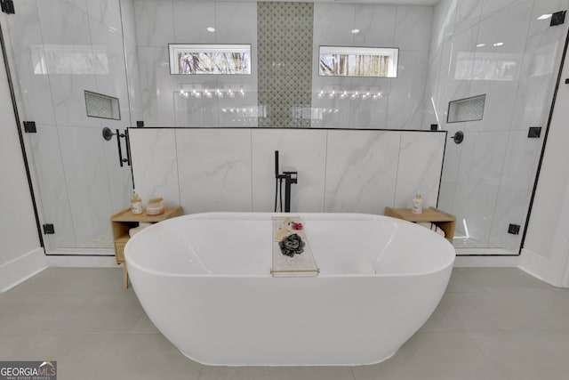 bathroom featuring tile walls, independent shower and bath, and tile patterned flooring