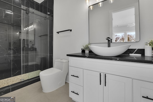 bathroom featuring toilet, vanity, an enclosed shower, and tile patterned flooring