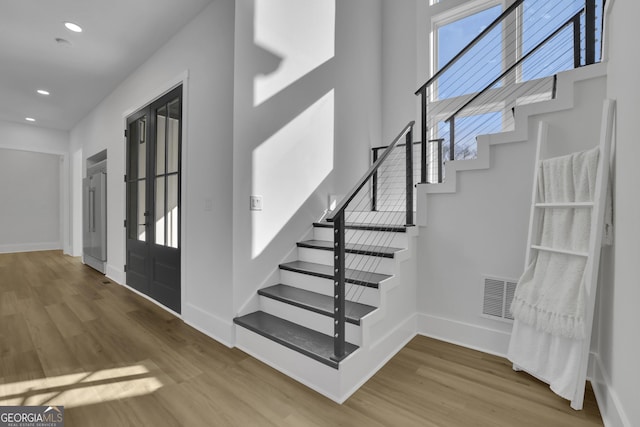 entryway with hardwood / wood-style floors