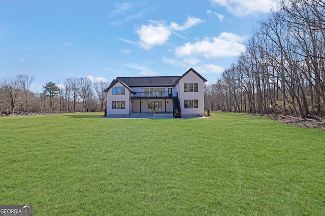 rear view of property with a lawn and a patio area