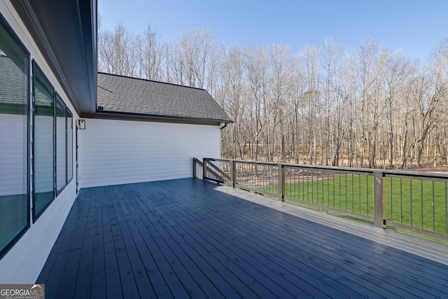 wooden terrace featuring a lawn