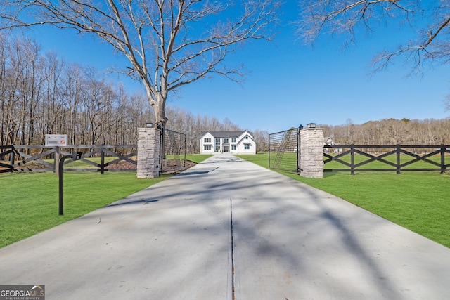 view of gate featuring a yard