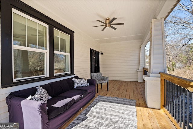 living room with ceiling fan, light hardwood / wood-style flooring, and a textured ceiling