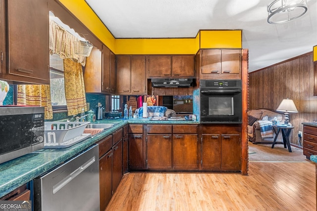 kitchen with light hardwood / wood-style floors, sink, and black appliances