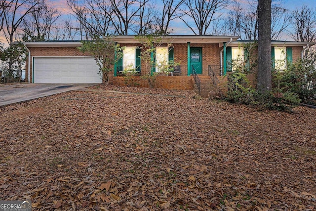 single story home with covered porch and a garage