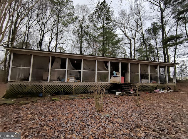 back of house featuring a sunroom