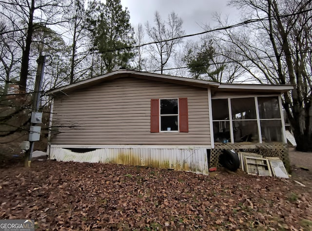 view of side of home featuring a sunroom