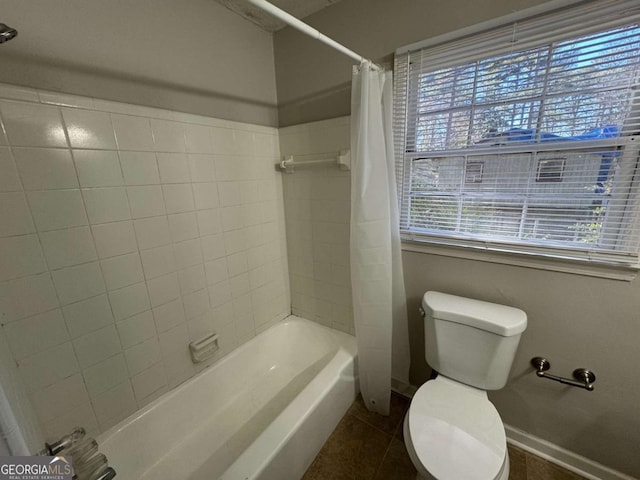 bathroom featuring shower / bath combo with shower curtain, tile patterned floors, and toilet