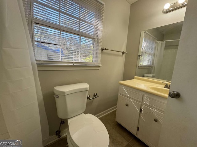 bathroom with toilet, vanity, walk in shower, and tile patterned flooring