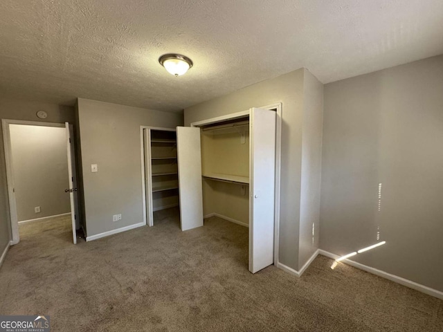 unfurnished bedroom featuring a textured ceiling and carpet