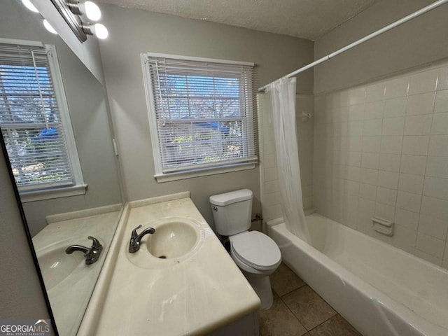 full bathroom featuring vanity, tile patterned flooring, plenty of natural light, and a textured ceiling