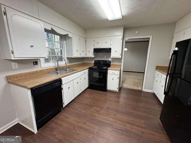 kitchen featuring black appliances, sink, dark wood-type flooring, a textured ceiling, and white cabinets