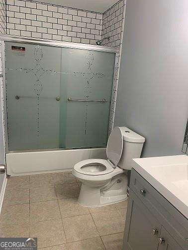 full bathroom with toilet, vanity, and combined bath / shower with glass door