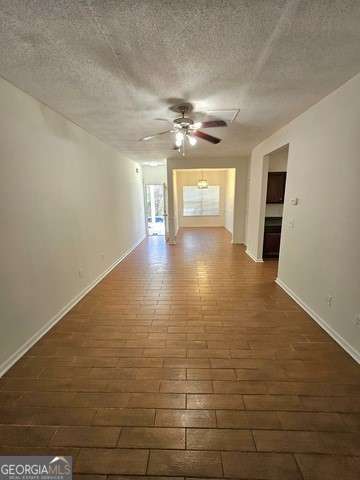 spare room with ceiling fan and a textured ceiling