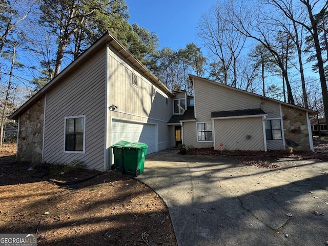 back of house featuring a garage