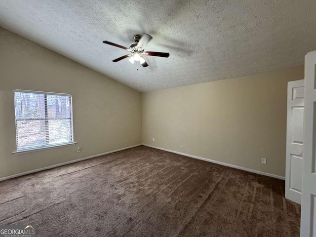 carpeted spare room featuring vaulted ceiling, ceiling fan, and a textured ceiling