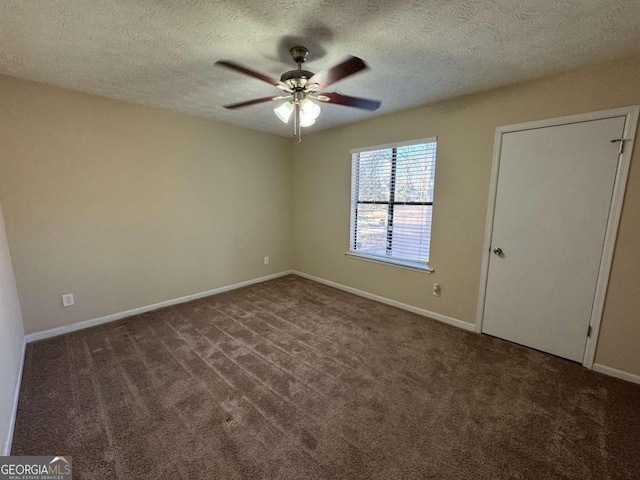 carpeted empty room with ceiling fan and a textured ceiling