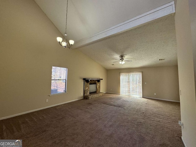 unfurnished living room featuring ceiling fan with notable chandelier, a textured ceiling, a stone fireplace, and carpet flooring