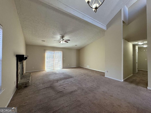 unfurnished living room featuring carpet, ceiling fan, a brick fireplace, and a textured ceiling