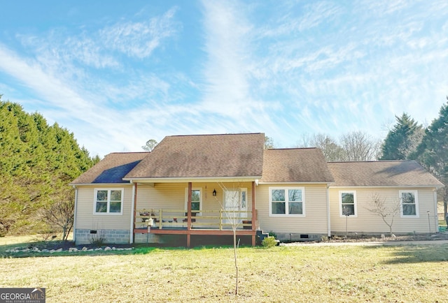 rear view of property featuring a yard