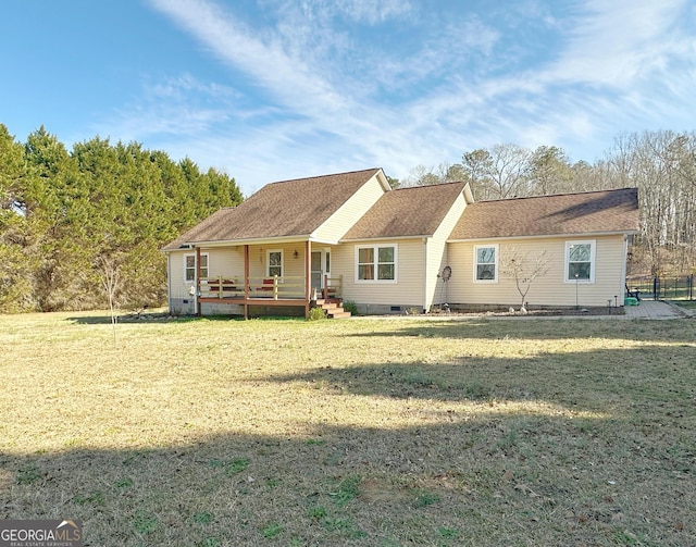 view of front of property with a deck and a front lawn