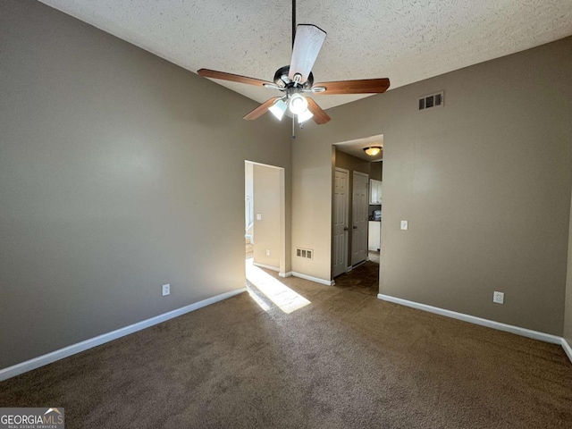 carpeted spare room with ceiling fan and a textured ceiling