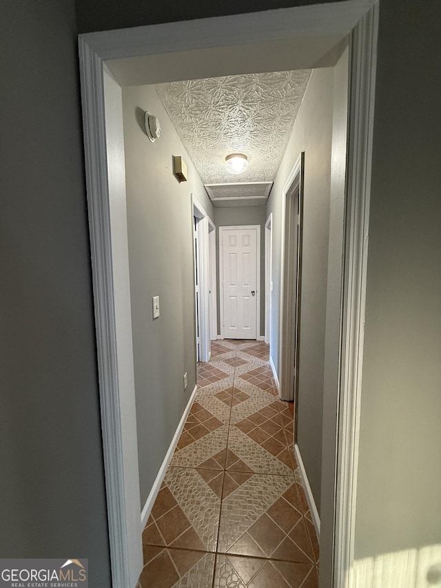 hallway with tile patterned flooring