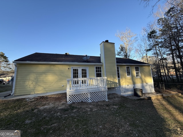 back of property with a wooden deck