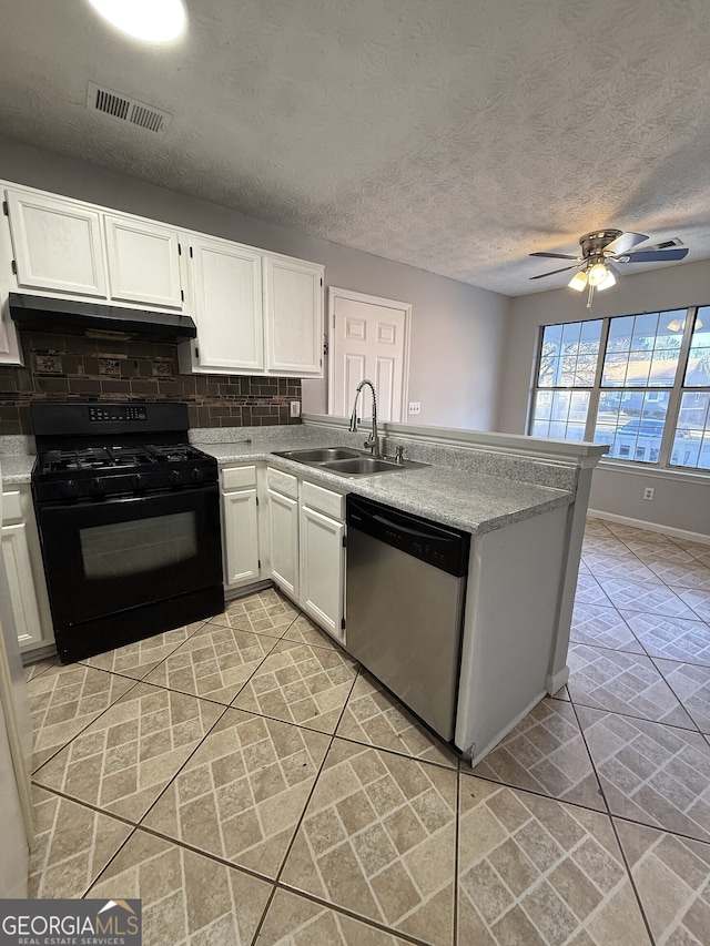 kitchen with stainless steel dishwasher, sink, black gas range oven, and white cabinetry