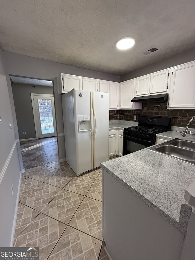 kitchen featuring sink, white cabinets, white refrigerator with ice dispenser, and black range with gas cooktop