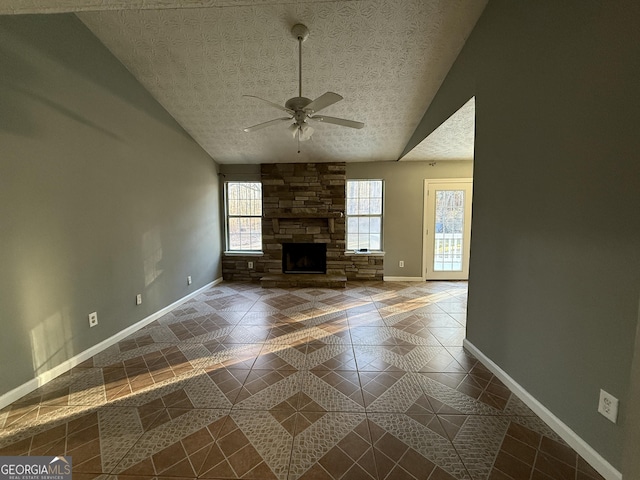 unfurnished living room featuring ceiling fan, a textured ceiling, a healthy amount of sunlight, and vaulted ceiling