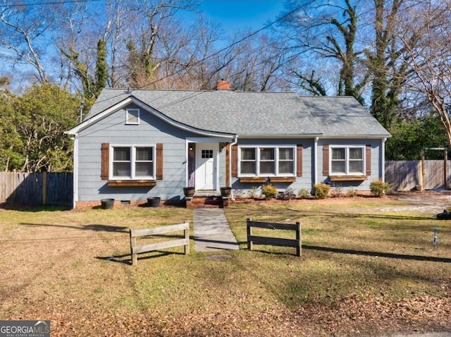 single story home featuring a front lawn